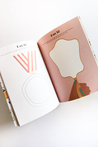 An open book with illustrations of a hand holding a mirror and abstract designs on a white surface.