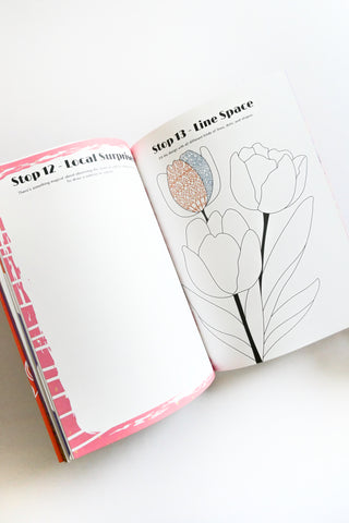 Open book with floral design and text on a white background