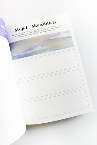 Open book with a page featuring a watercolor sky illustration on a white background