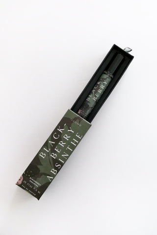 Blackberry absinthe bottle in packaging on a white background