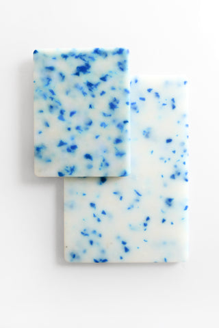 Two rectangular cutting boards with blue speckles on a white background