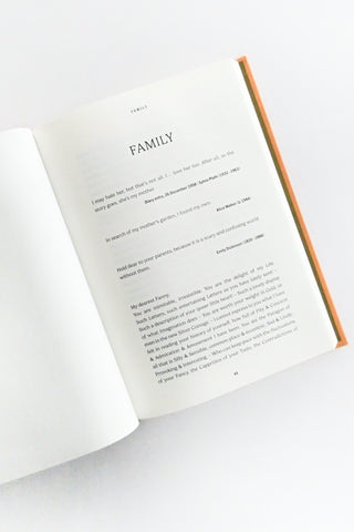 Open book with a pen on a white surface, focusing on the text and pen.