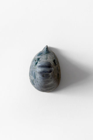 Handmade ceramic fish sculpture on a white background