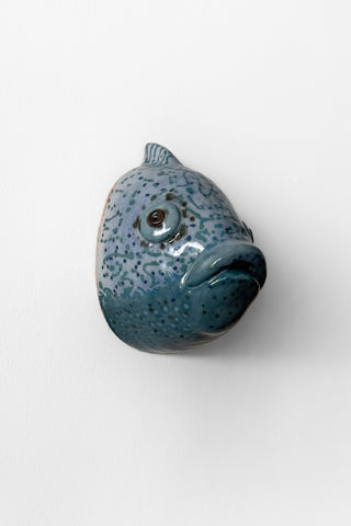 Blue ceramic fish-shaped sculpture on a white background