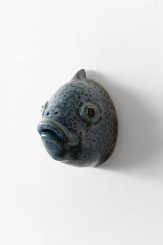Ceramic fish-shaped sculpture on a white background