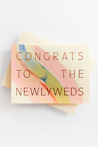 Greeting card with 'Congrats to the Newlyweds' text on a colorful abstract design.