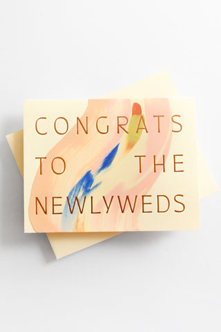 Greeting card with 'Congrats to the Newlyweds' text on a light background
