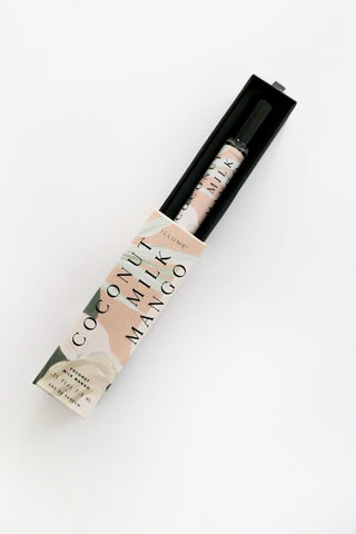 Roll-on bottle of coconut milk mango body lotion on a white background