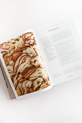 Open book with a dessert illustration on a white background