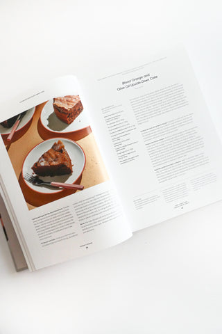Open cookbook showing a recipe for cake on a white surface