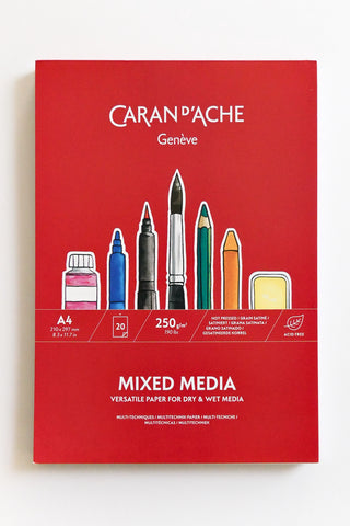 Caran d'Ache mixed media paper pack with illustration of art supplies on a red background