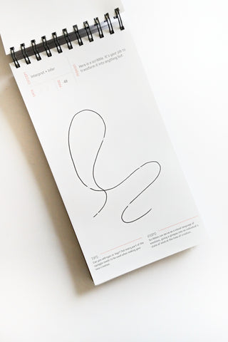 Notebook with a minimalist line drawing on a white background