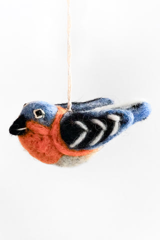 Felted bird ornament hanging on a white background