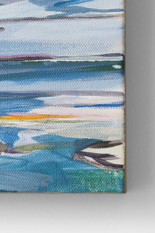 Close-up of a colorful abstract painting with blue, green, and white patterns on a gray background.