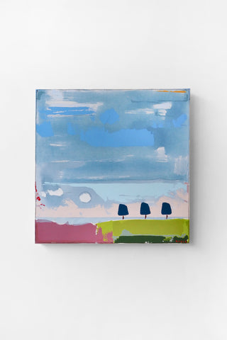 Abstract painting of a landscape with trees and a blue sky on a white wall.