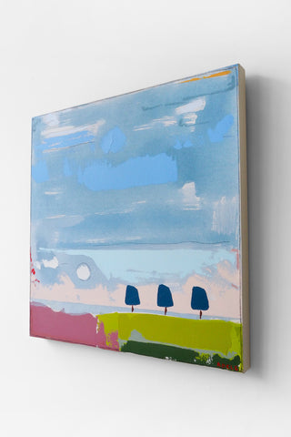 Abstract painting of a landscape with blue sky, green field, and trees on a white wall.