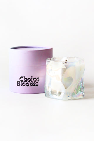 Candle in a glass holder with a purple lid labeled 'Choice Blooms' on a white background
