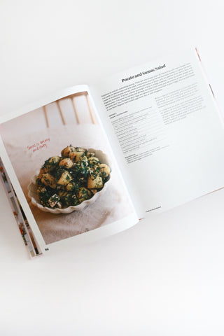 Open cookbook showing a page with a recipe and an image of a dish.
