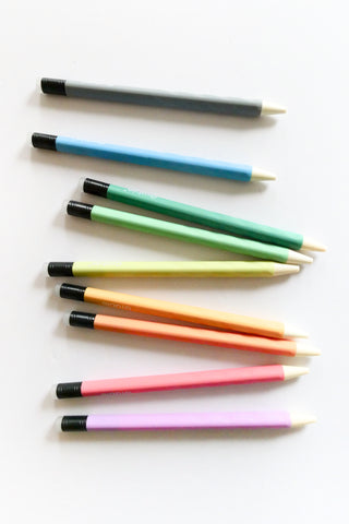 Set of colorful pens with black caps on a white background