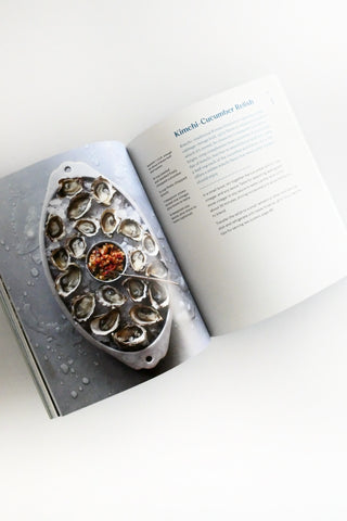 Oyster shell with a central gemstone on an open book
