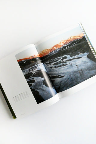 Open book showing a photograph of a snowy landscape with a sunset.