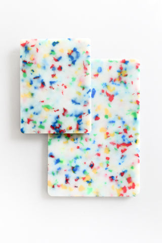 Two colorful confetti-patterned cutting boards on a white background