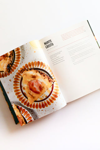 Open cookbook showing a Monte Cristo pizza recipe on a white background