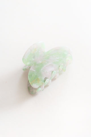 Pale green hair clip on a white background