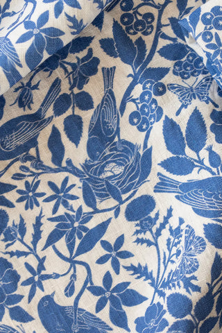 Blue floral and bird pattern on beige fabric