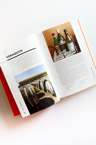 Open book with images of bottles and text on a white background