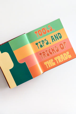 Open book with colorful text on a white background