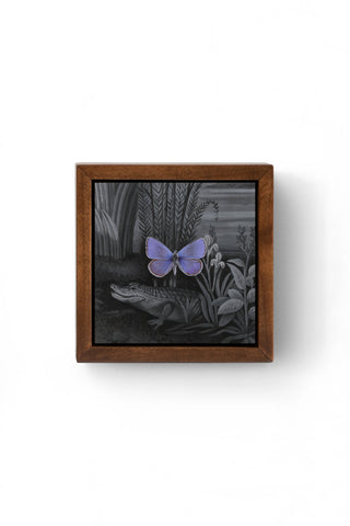 Framed artwork with a butterfly on a black and white background
