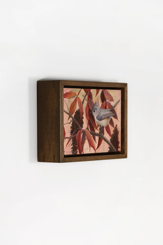 Small wooden box with a bird and leaf design on a white background