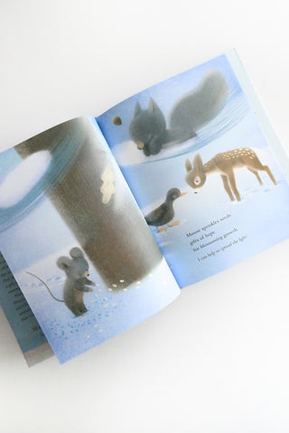 Open book with illustrations of animals on a light blue background