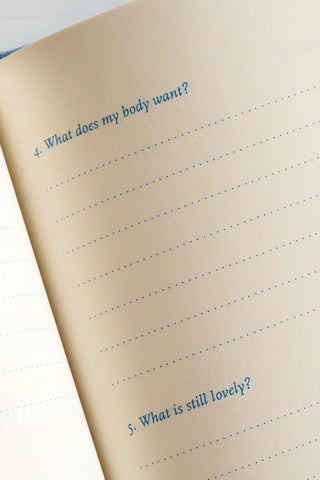 Notebook page with lined paper and blue text on a light background