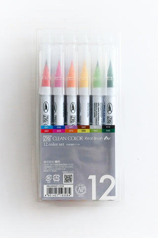 Pack of ZIG Clean Color Real Brush markers with colorful tips under clear caps on a white background